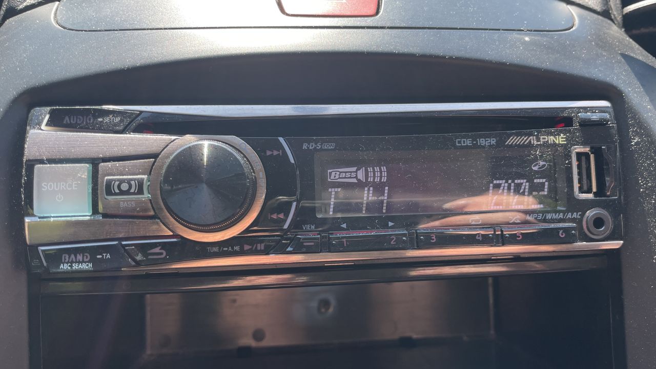 A car's CD player and burned CDs, on a hot day
