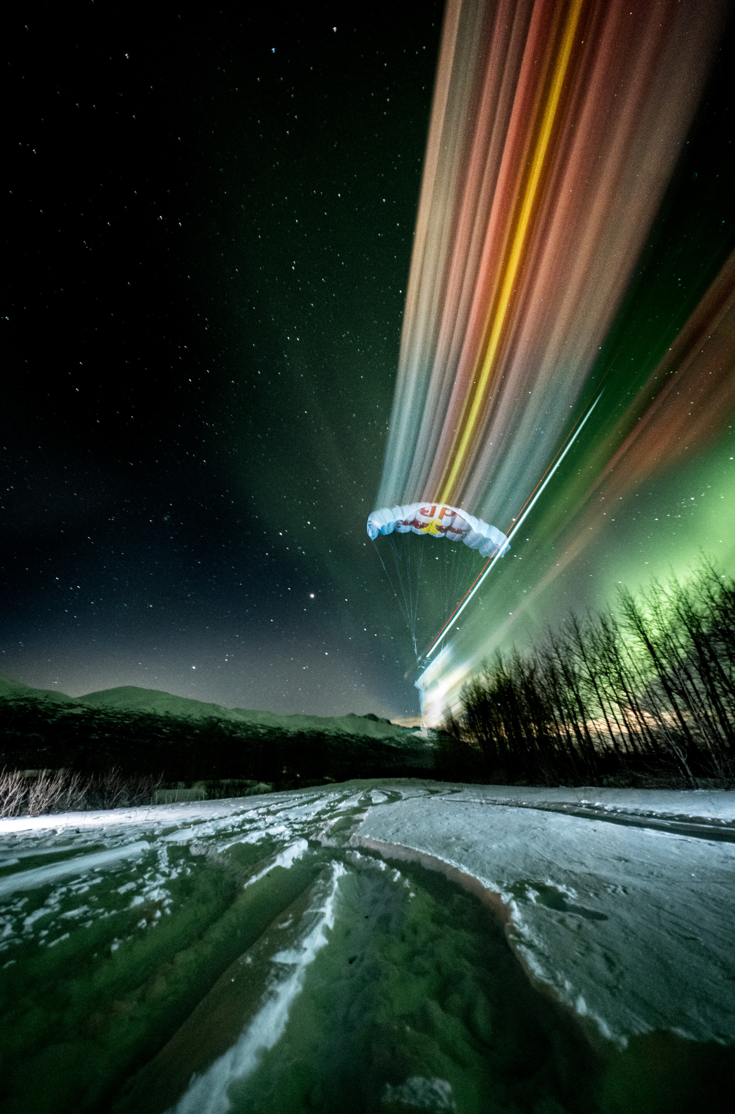 Jeff Provenzano and Jon DeVore wingsuit skydiving under the Aurora Borealis near Palmer, Alaska on March 23, 2026.
