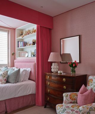 An example of how to arrange a small bedroom with a red bed alcove and built-in shelving.