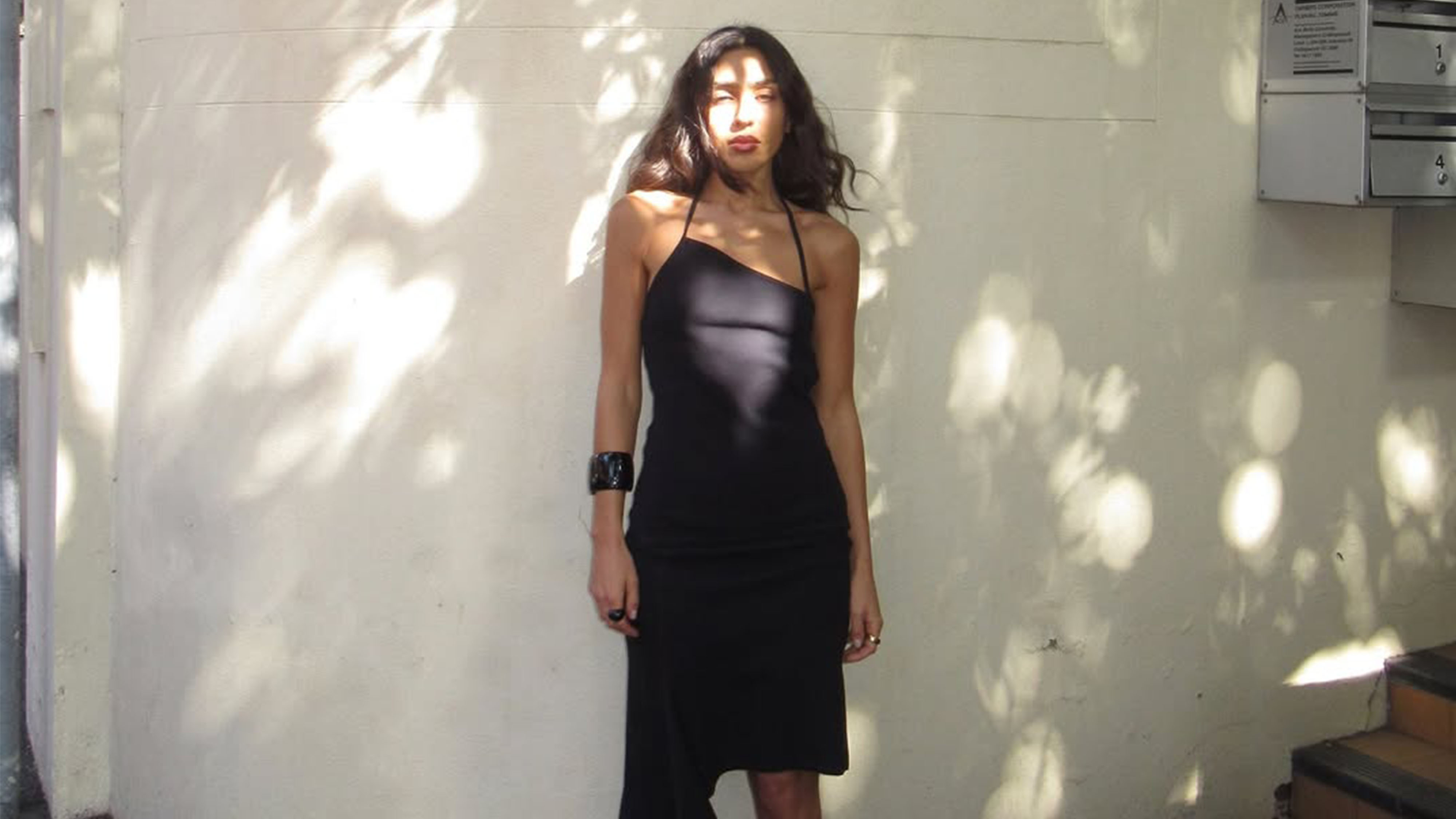 Camelia Farhoodi wearing an asymmetrical dress.