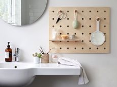 Cheap bathroom ideas: Peg board storage in a white bathroom 