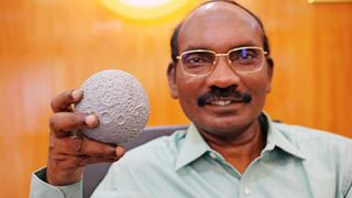 K. Sivan, head of the India Space Research Organisation, holds a lunar model on Aug. 26, 2019, as the country's Chandrayaan-2 spacecraft flew toward the moon.