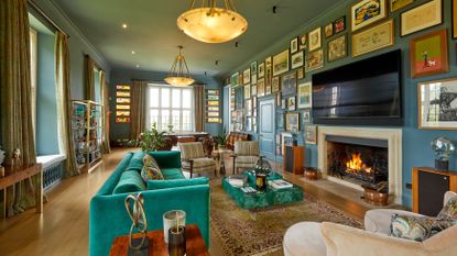 Eclectic living room with blue paint and a gallery wall