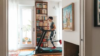 Best treadmills: Image shows woman on treadmill in bright apartment