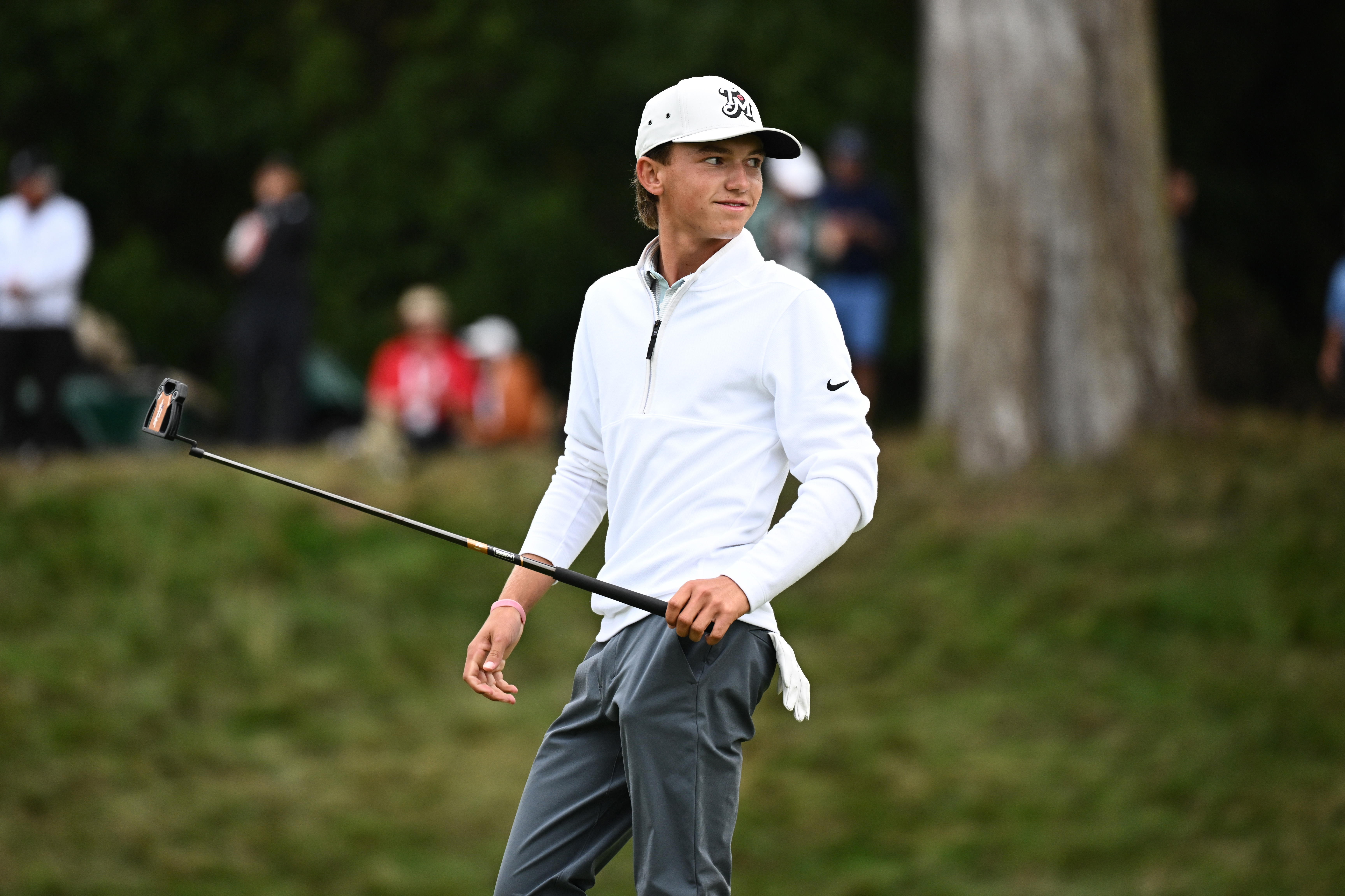 Miles Russell lifts his putter after holing a putt