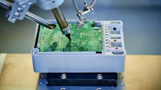 A CPU being manufactured by robotics on a workbench