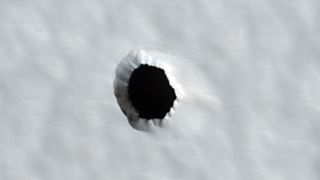 A white background with a black circle that appears to be a hole.