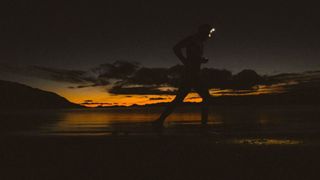 Brian Sharp running at sunset wearing a headlamp