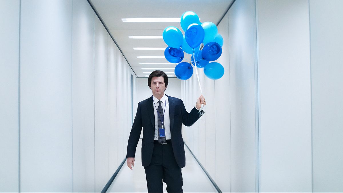 A still from a promo image for the second season of Severance showing the character Mark holding blue balloons in a hallway