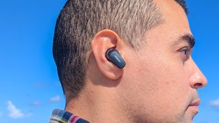 Hero image for best noise-cancelling earbuds showing Bose QuietComfort Earbuds 2 in black as worn by reviewer