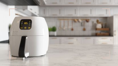 A white air fryer on a kitchen countertop to support a question around where should you place an air fryer in your kitchen