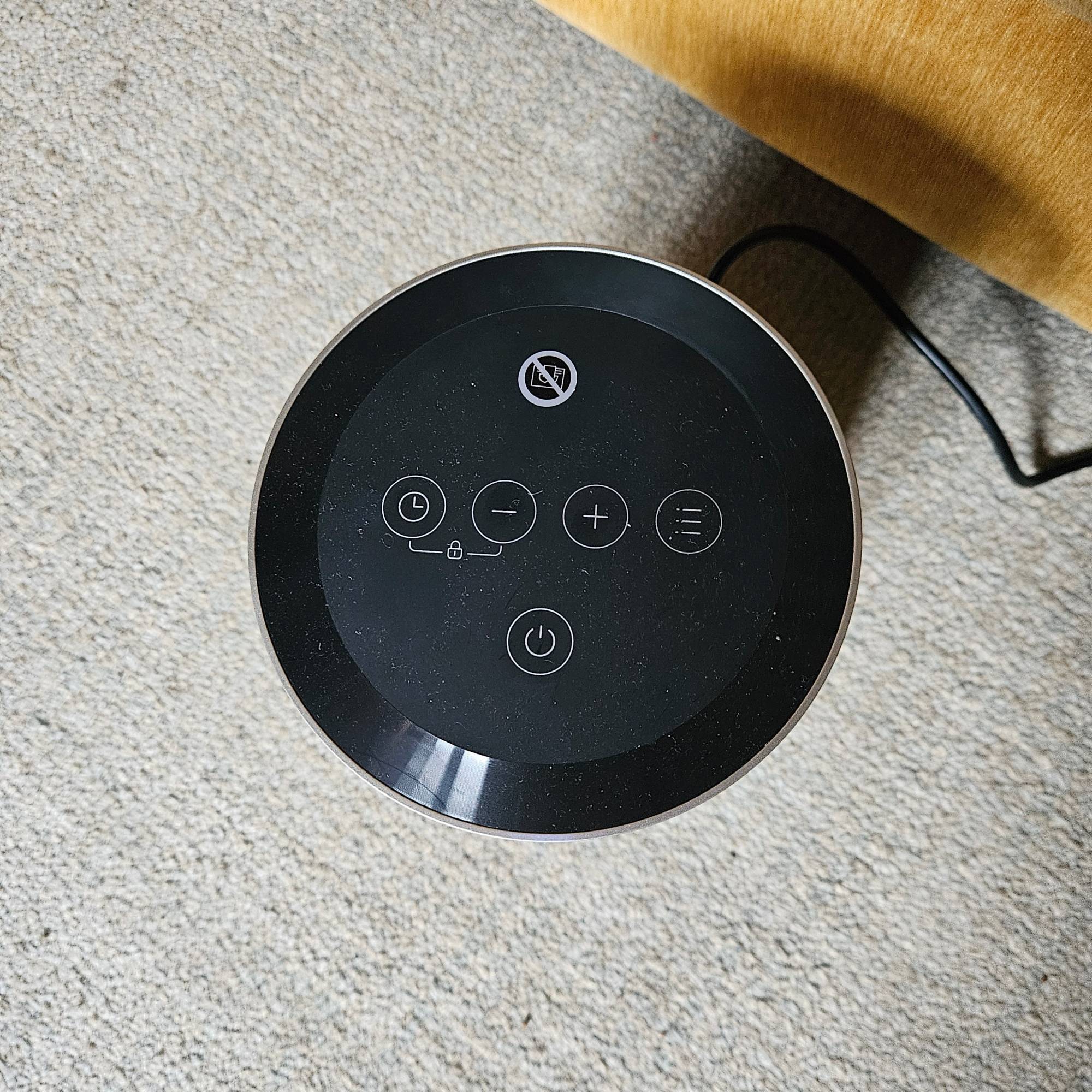 dreo fan heater control on pale rug from above