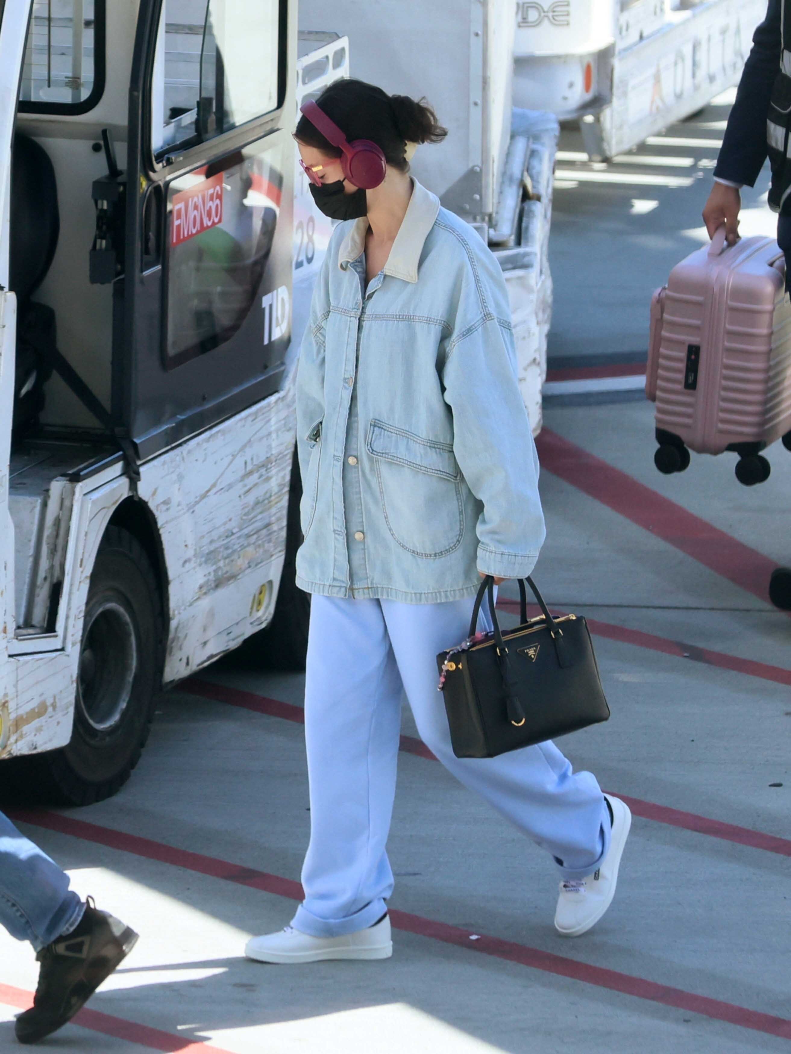 Selena Gomez was spotted outside LAX in an oversize jean jacket and chunky white sneakers