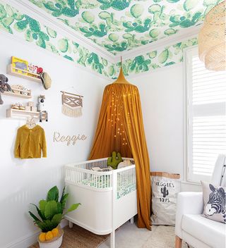 white nursery with ceiling in green wallpaper