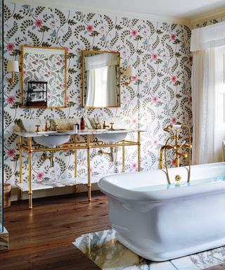 Bathroom with floral wallpaper and freestanding bath