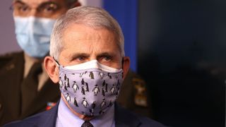 Dr. Anthony Fauci, director of the National Institute of Allergy and Infectious Diseases, wears two protective face masks during a White House Coronavirus Task Force press briefing