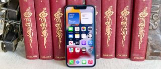 iphone 13 mini display on leaning against books