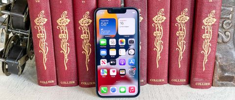 iphone 13 mini display on leaning against books