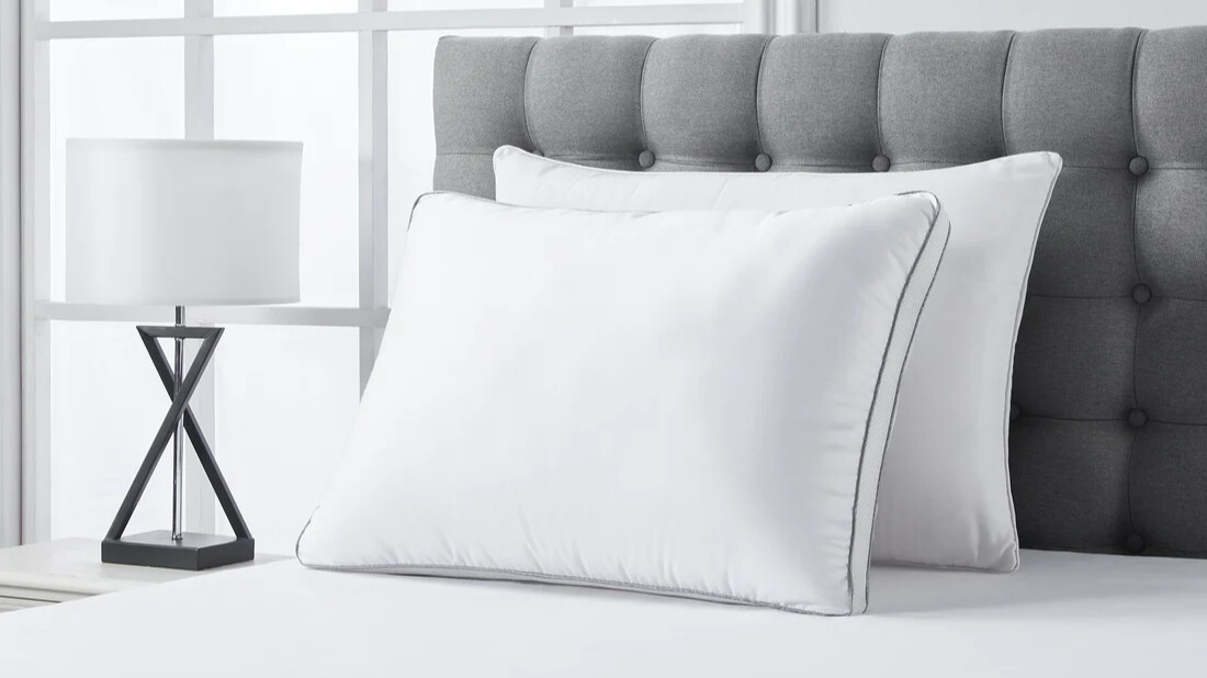 A set of Infrared Dream Pillow placed on the bed in a brightly lit room