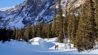People hiking in the beautiful Rocky Mountains in winter