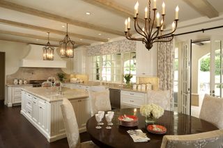 Large white kitchen with chandelier lighting