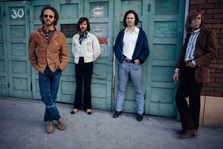 The Doors standing in front of a garage