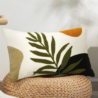 throw pillow with a leafy tufted pattern in neutral shades