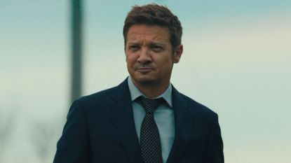 Jeremy Renner looks at something offscreen