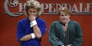 Chris Farley and Patrick Swayze standing on stage in robes during an SNL sketch about Chippendale's.