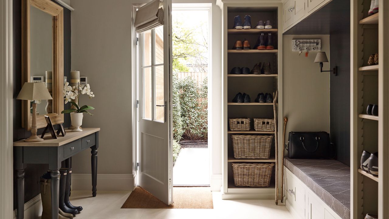 spacious entryway with console table, built in bench and storage shelves