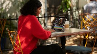 iPad Pro 2021 M1 review: image shows woman using the iPad Pro 2021 M1 tablet