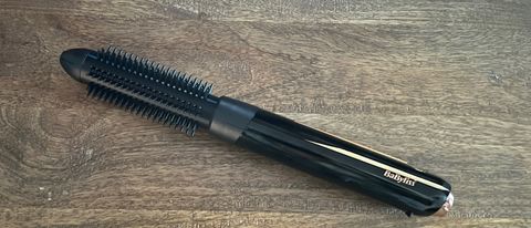 The BaByliss 900 cordless hot brush on a wooden table