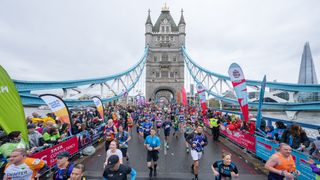 Runners cross Tower Bridge during The 2023 London Marathon