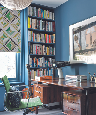 Office with blue walls and tall blue bookshelves