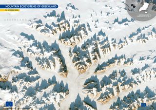 A series of snow-covered mountain peaks jut out against a white landscape in an image seen from space