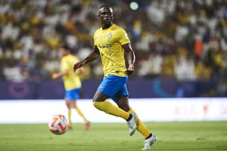 Sadio Mane on the ball for Al-Nassr in a game against Al-Taawon in the Saudi Pro League in August 2023.