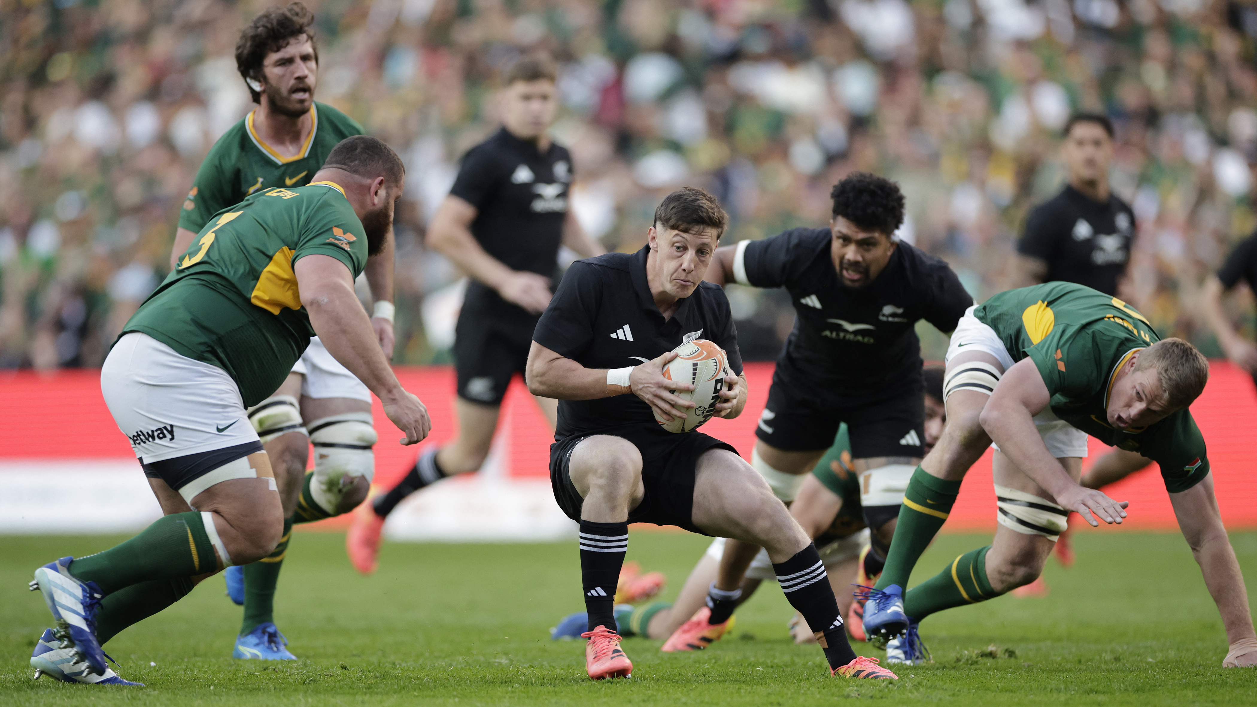 New Zealand's fly-half Ruben Love runs with the ball during the Rugby's Greatest Rivalry international rugby union match between South Africa and New Zealand at Ellis Park Stadium in Johannesburg