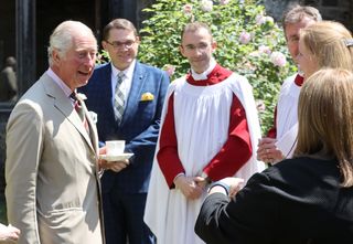 Prince Charles, Prince of Wales (L) speaks to guests as he attends a service for the Centenary of the Church in Wales at St David’s Cathedral on July 08, 2021 in St Davids, Wales