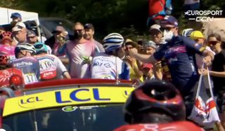 Thibaut Pinot is taken down by a handout from soigneur on stage 8