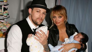 Nicole Richie and Joel Madden holding their babies