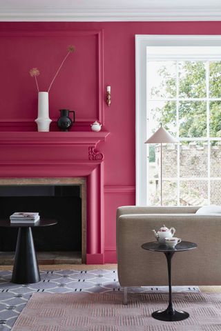 pink living room with fireplace, white ceiling and woodwork