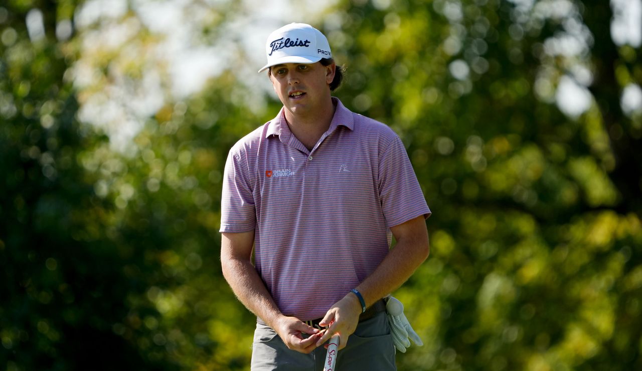 Trace Crowe walks with his putter in hand