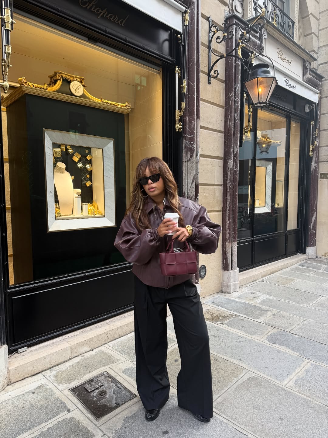 Ellie in burgundy leather bomber jacket