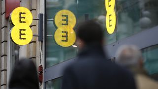 A view of an EE mobile phone store in London, UK, with people walking outside