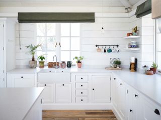 white kitchen with panelled walls and open shelving