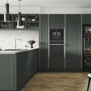 kitchen with dark green cabinets and worktop