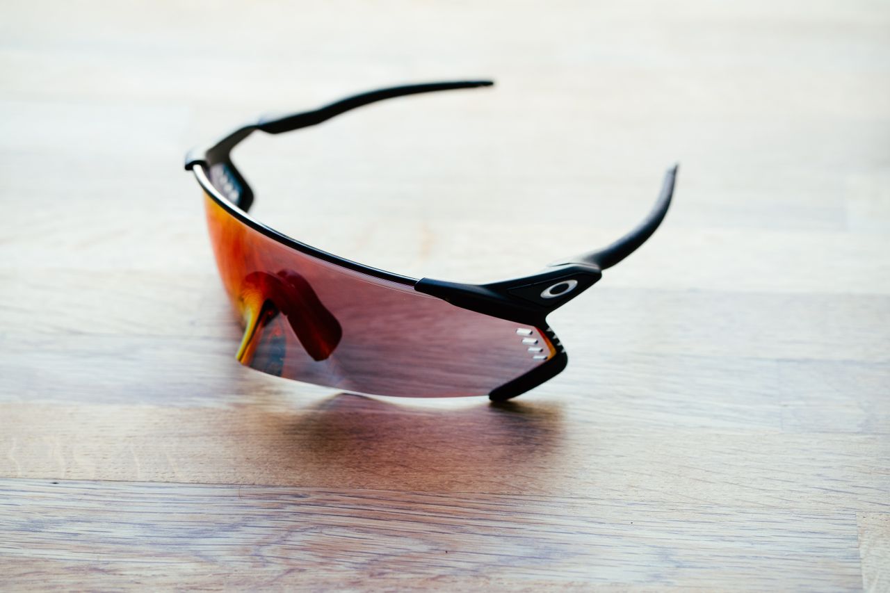 A set of large wraparound sports glasses on a wooden surface
