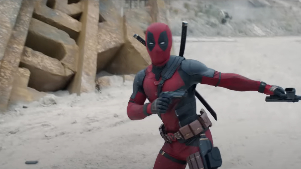 Deadpool reloads his pistols next to a wrecked Fox logo in Deadpool and Wolverine