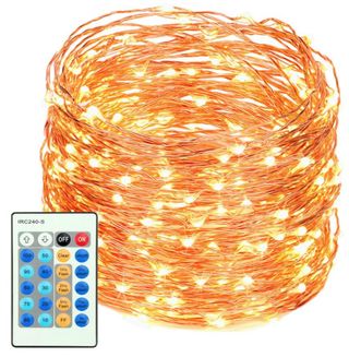 A coil of golden string lights with a remote control. 