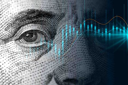 close-up of Benjamin Franklin's face on a US 100 dollar note with stocks and shares overlaid